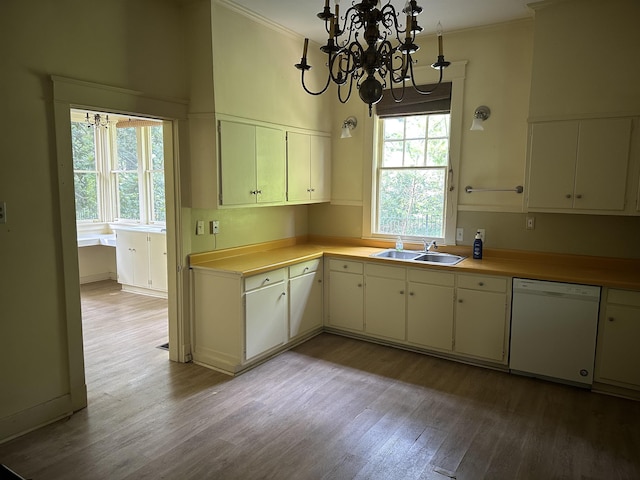 4042 Goodlett Cv, Memphis, TN 38111 - kitchen featuring white dishwasher, light wood-type flooring, crown molding, a chandelier, and light countertops