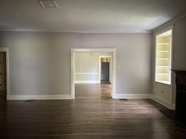 4042 Goodlett Cv, Memphis, TN 38111 - empty room featuring dark wood finished floors, crown molding, and a chandelier