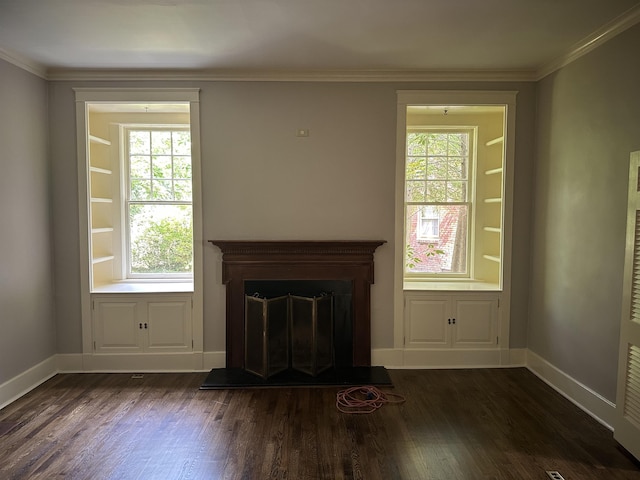 4042 Goodlett Cv, Memphis, TN 38111 - unfurnished living room featuring healthy amount of natural light, dark wood-style flooring, a fireplace with raised hearth, and crown molding