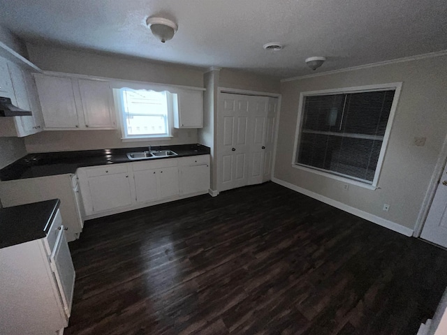 4786 Chevron Rd, Memphis, TN 38118 - kitchen with dark countertops, dark wood finished floors, white cabinetry, a textured ceiling, and extractor fan