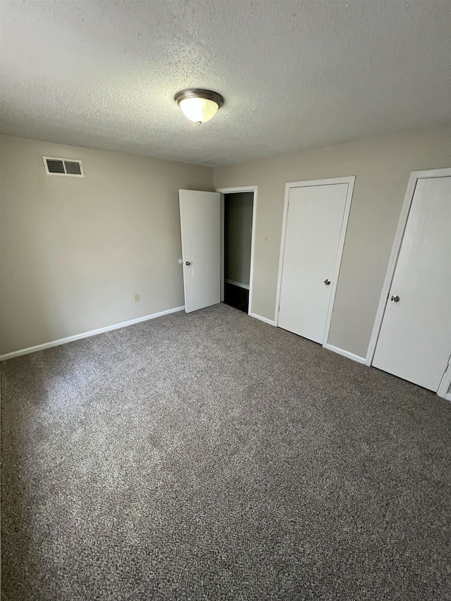 4786 Chevron Rd, Memphis, TN 38118 - unfurnished bedroom with multiple closets, carpet floors, and a textured ceiling