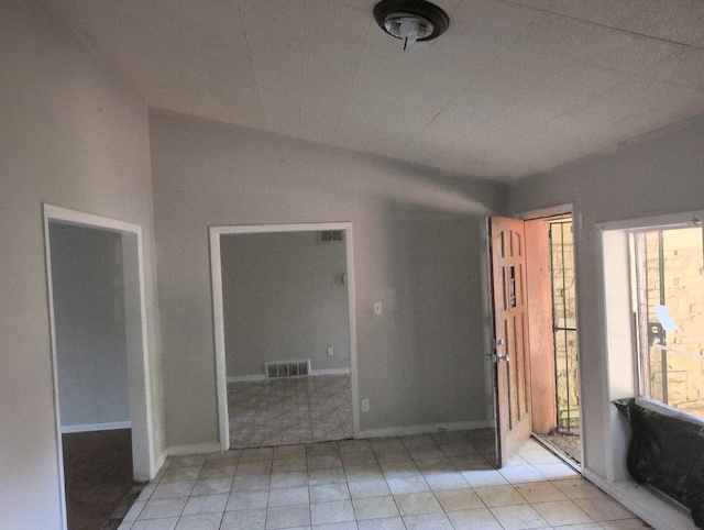 4915 Foxhall Cv, Memphis, TN 38118 - empty room featuring lofted ceiling and light tile patterned floors