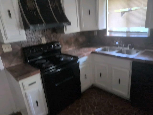 4915 Foxhall Cv, Memphis, TN 38118 - kitchen with black electric range oven, white cabinets, decorative backsplash, and light countertops