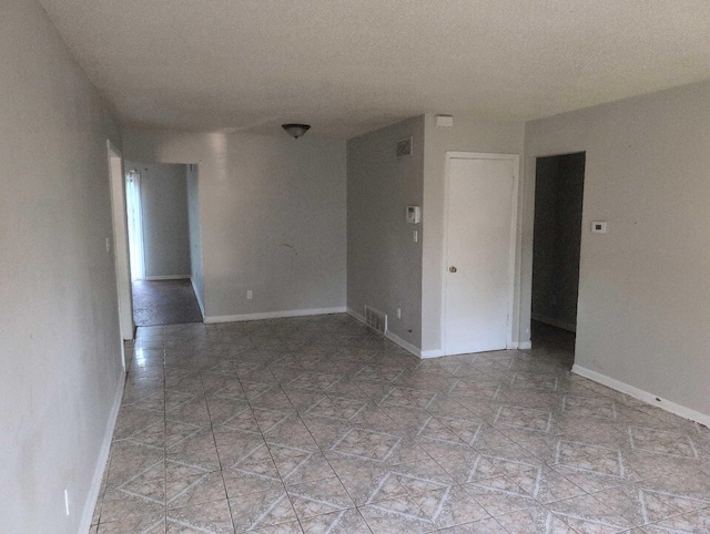 4915 Foxhall Cv, Memphis, TN 38118 - spare room with baseboards and a textured ceiling