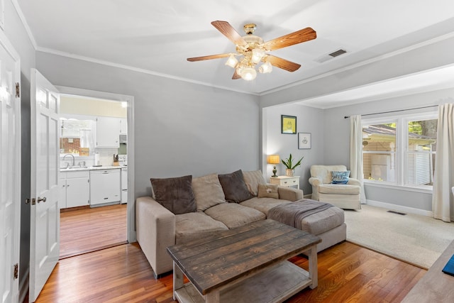 4670 Kaye Rd, Memphis, TN 38117 - living room with light wood-type flooring, a ceiling fan, and crown molding