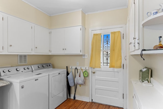 4670 Kaye Rd, Memphis, TN 38117 - washroom featuring cabinet space, washer and clothes dryer, ornamental molding, and light wood-style floors