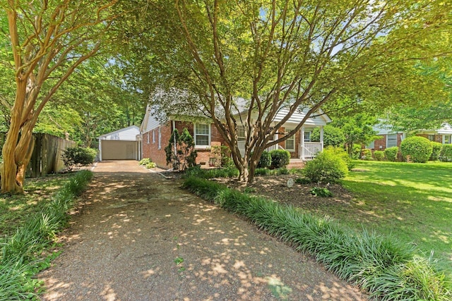 4670 Kaye Rd, Memphis, TN 38117 - view of property hidden behind natural elements featuring brick siding, an outdoor structure, and a detached garage
