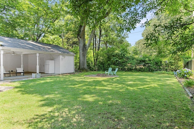 4670 Kaye Rd, Memphis, TN 38117 - view of grassy yard featuring an outdoor fire pit, a patio, and ceiling fan