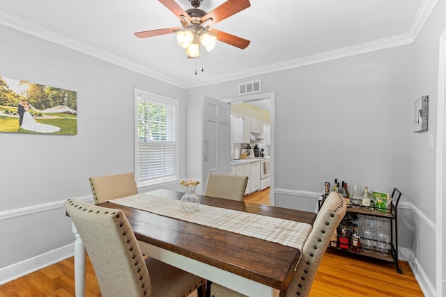 4670 Kaye Rd, Memphis, TN 38117 - dining area featuring ornamental molding, light wood-style floors, and a ceiling fan