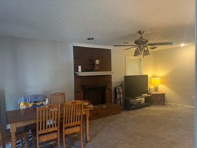 3115 S Wesley Ct, Memphis, TN 38119 - dining room featuring ceiling fan, a brick fireplace, a textured ceiling, and carpet flooring