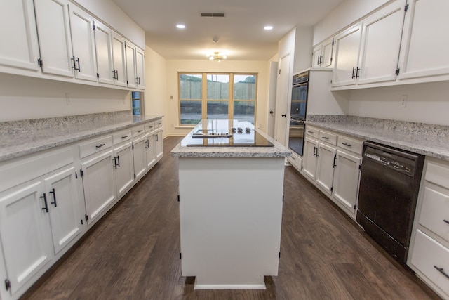 7726 Stout Rd, Germantown, TN 38138 - kitchen with black appliances, a center island, white cabinets, dark wood-style floors, and recessed lighting