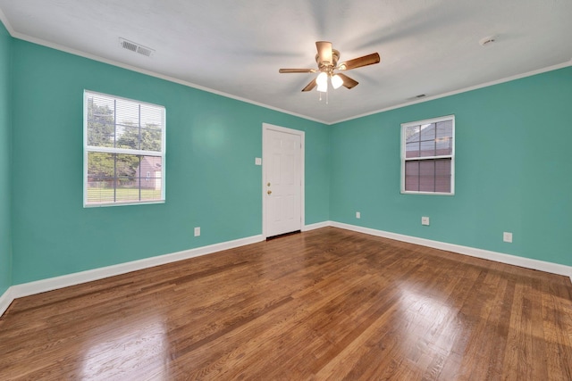 2154 N Hubert Cir, Memphis, TN 38108 - empty room with a ceiling fan, plenty of natural light, dark wood-type flooring, and ornamental molding