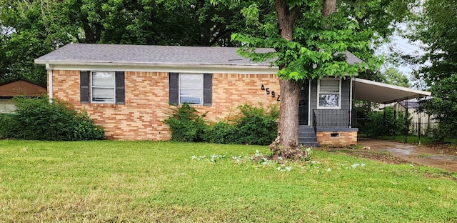 4592 Neely Rd, Memphis, TN 38109 - view of front facade with brick siding, a carport, concrete driveway, and roof with shingles