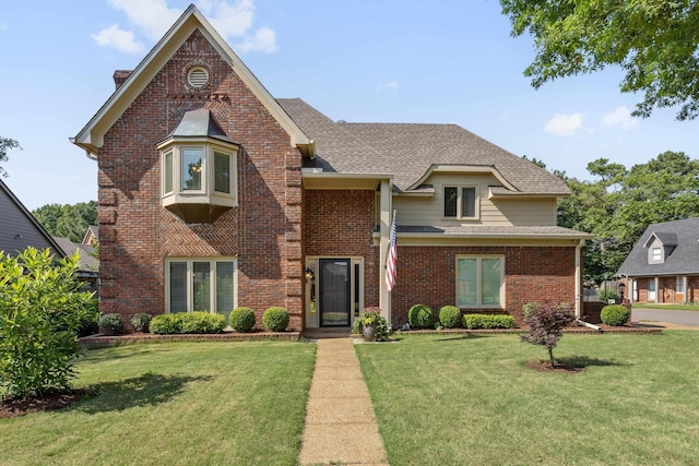 8394 N Westfair Cir N, Germantown, TN 38139 - view of front of home with brick siding, a front yard, a shingled roof, and a chimney