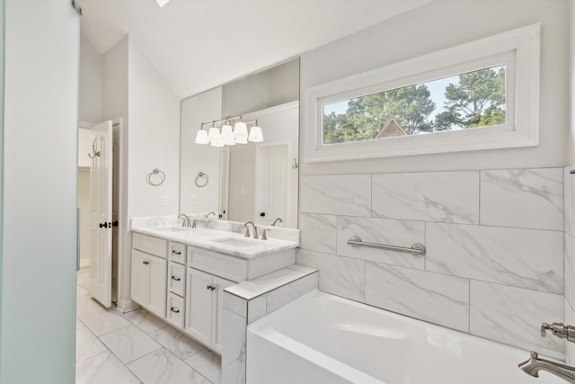 8394 N Westfair Cir N, Germantown, TN 38139 - bathroom featuring marble look tiles, a garden tub, double vanity, and lofted ceiling