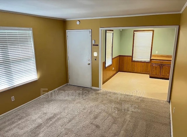 1750 Sea Isle Rd, Memphis, TN 38117 - empty room with light carpet, ornamental molding, and wood walls