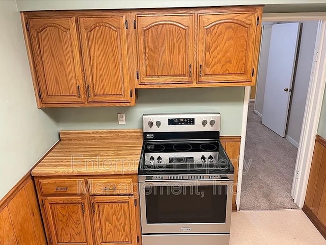 1750 Sea Isle Rd, Memphis, TN 38117 - kitchen with stainless steel electric stove, light countertops, and brown cabinetry