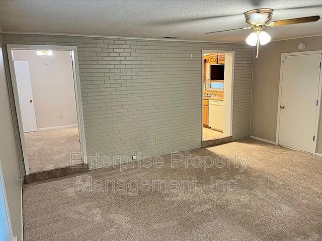 1750 Sea Isle Rd, Memphis, TN 38117 - unfurnished room with light colored carpet, brick wall, ceiling fan, and a textured ceiling
