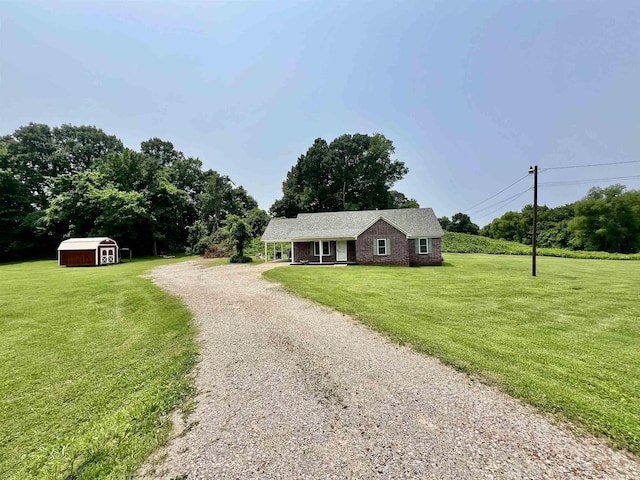 199 Bucksnort Rd, Covington, TN 38019 - ranch-style house with a storage unit, driveway, a front yard, and brick siding