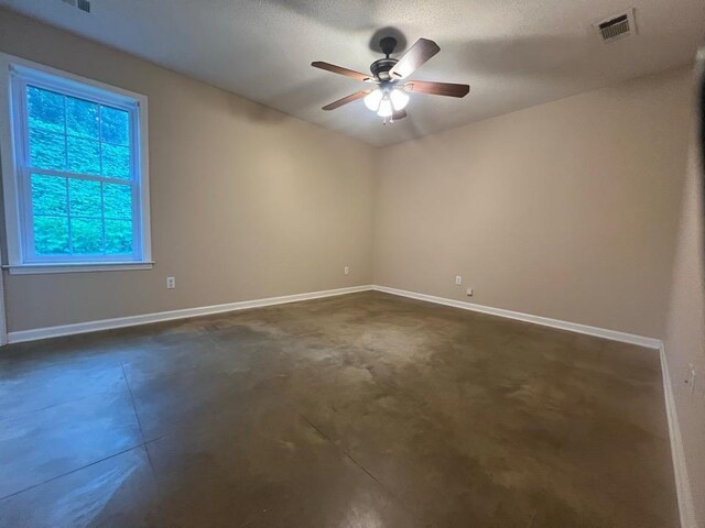 199 Bucksnort Rd, Covington, TN 38019 - empty room featuring a ceiling fan and concrete flooring
