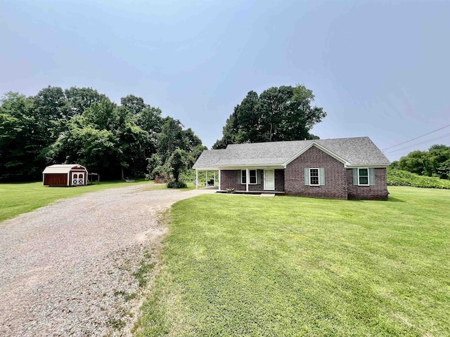 199 Bucksnort Rd, Covington, TN 38019 - single story home with a shed, driveway, brick siding, and a front yard