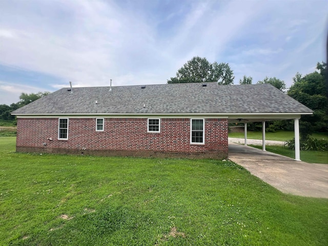 199 Bucksnort Rd, Covington, TN 38019 - view of property exterior featuring concrete driveway, an attached carport, a lawn, and a shingled roof