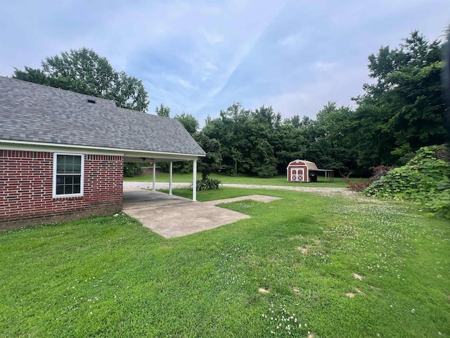 199 Bucksnort Rd, Covington, TN 38019 - view of grassy yard with a shed, a carport, and driveway