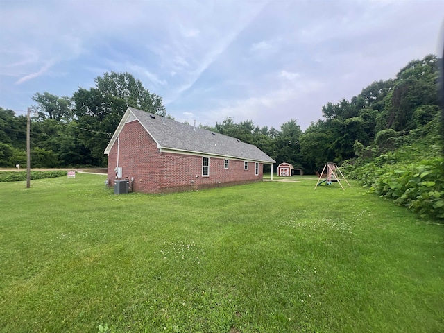 199 Bucksnort Rd, Covington, TN 38019 - view of home's exterior featuring a yard, a storage shed, and brick siding
