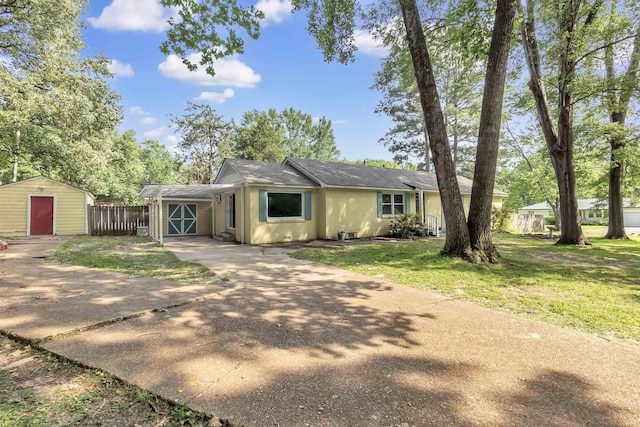 3024 Keats Rd, Bartlett, TN 38134 - view of front of property with concrete driveway, stucco siding, a shed, and roof with shingles