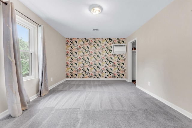3024 Keats Rd, Bartlett, TN 38134 - unfurnished room with an AC wall unit, carpet, and wallpapered walls