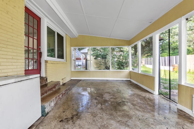 3024 Keats Rd, Bartlett, TN 38134 - unfurnished sunroom featuring healthy amount of natural light, unfinished concrete flooring, wood walls, and lofted ceiling