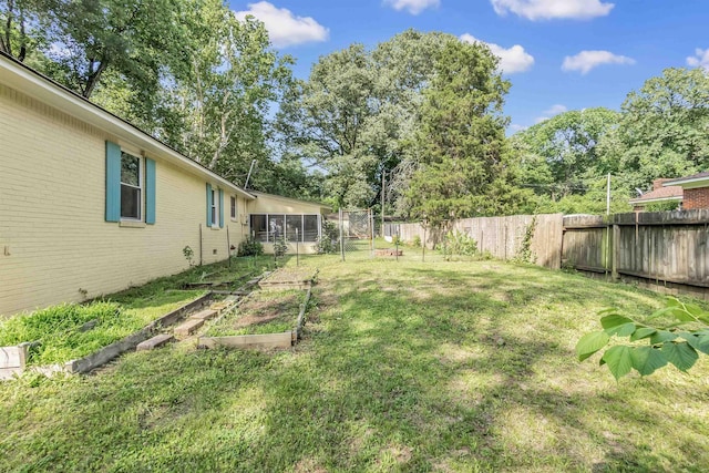 3024 Keats Rd, Bartlett, TN 38134 - fenced backyard with a vegetable garden and a sunroom