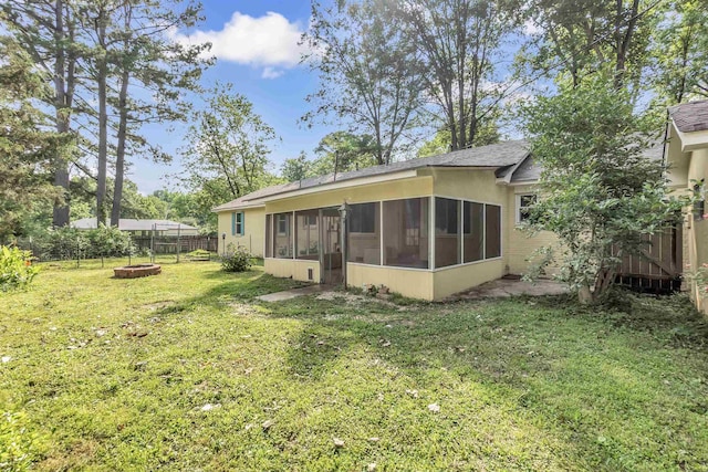 3024 Keats Rd, Bartlett, TN 38134 - rear view of property featuring an outdoor fire pit, a sunroom, and a fenced backyard