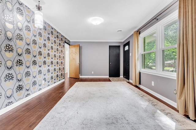 3024 Keats Rd, Bartlett, TN 38134 - empty room featuring dark wood finished floors, crown molding, and wallpapered walls