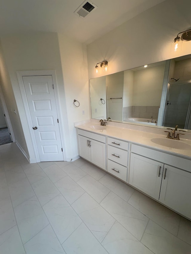 10289 March Meadows Way, Olive Branch, MS 38654 - bathroom featuring double vanity, a stall shower, marble look tiles, and a garden tub