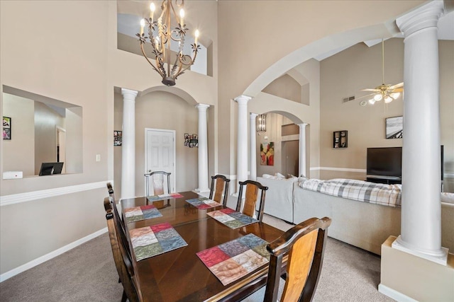 6806 Briarfield Ln, Bartlett, TN 38135 - carpeted dining room featuring a high ceiling, ceiling fan, ornate columns, arched walkways, and a chandelier