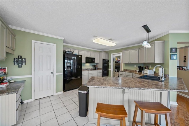 6806 Briarfield Ln, Bartlett, TN 38135 - kitchen featuring black appliances, a peninsula, ornamental molding, a kitchen breakfast bar, and light tile patterned flooring