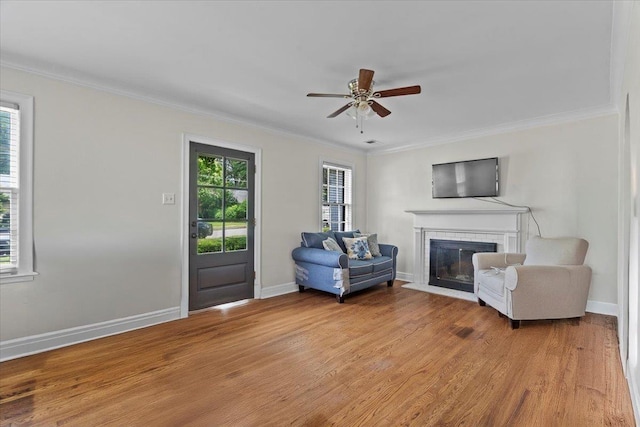 193 Alexander St, Memphis, TN 38111 - living area with a fireplace, ornamental molding, light wood-style floors, and ceiling fan