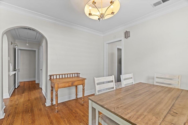 193 Alexander St, Memphis, TN 38111 - dining area with attic access, wood finished floors, and crown molding