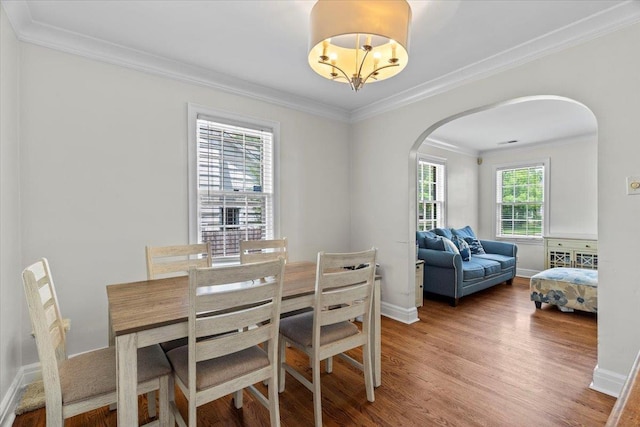 193 Alexander St, Memphis, TN 38111 - dining area with arched walkways, wood finished floors, crown molding, and a chandelier