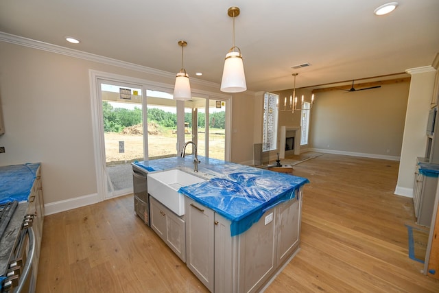 1710 Slocum Rd, Hernando, MS 38632 - kitchen featuring crown molding, stainless steel range oven, a fireplace, light wood-style flooring, and recessed lighting