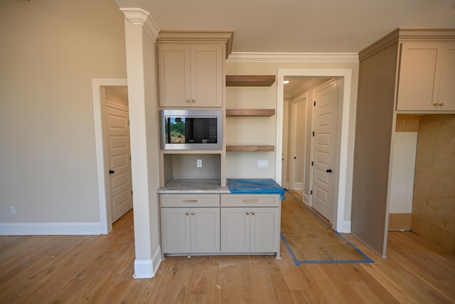 1710 Slocum Rd, Hernando, MS 38632 - kitchen featuring stainless steel microwave, open shelves, and light wood-style flooring