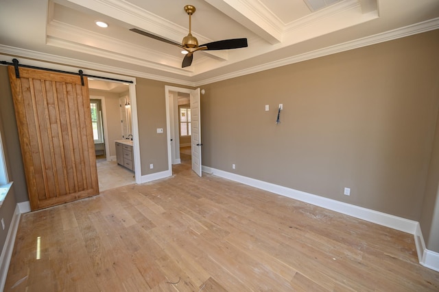 1710 Slocum Rd, Hernando, MS 38632 - unfurnished bedroom featuring a barn door, crown molding, light wood finished floors, a raised ceiling, and ensuite bathroom
