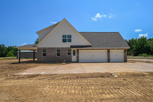 1710 Slocum Rd, Hernando, MS 38632 - view of front of house featuring brick siding, a garage, driveway, and roof with shingles