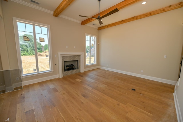 1710 Slocum Rd, Hernando, MS 38632 - unfurnished living room featuring beam ceiling, plenty of natural light, a ceiling fan, light wood-type flooring, and crown molding