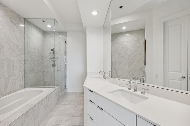 717 Riverside Dr Unit 1403, Memphis, TN 38103 - full bath featuring marble look tiles, recessed lighting, a garden tub, double vanity, and a stall shower