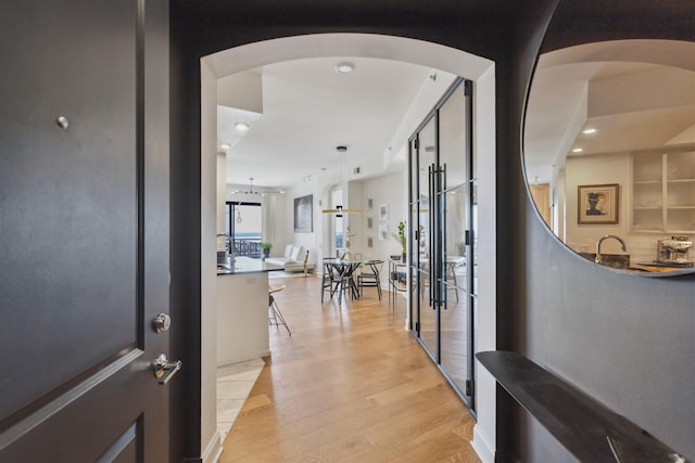 717 Riverside Dr Unit 1403, Memphis, TN 38103 - hall with light wood-type flooring, arched walkways, and recessed lighting