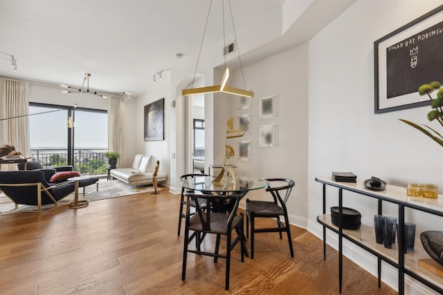 717 Riverside Dr Unit 1403, Memphis, TN 38103 - dining space with wood finished floors and rail lighting
