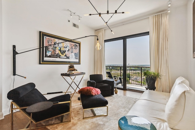 717 Riverside Dr Unit 1403, Memphis, TN 38103 - living room with rail lighting, a chandelier, and wood finished floors