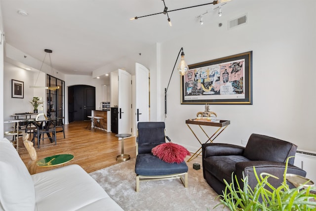 717 Riverside Dr Unit 1403, Memphis, TN 38103 - living room with arched walkways and light wood-type flooring
